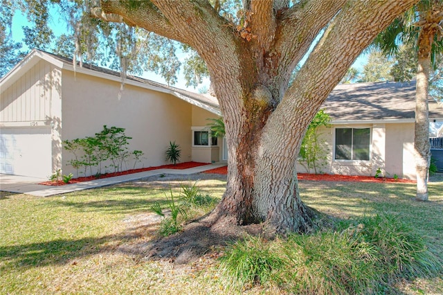 view of side of property with a garage and a yard