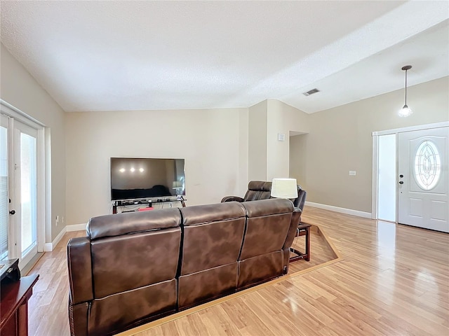 living room with french doors and light wood-type flooring