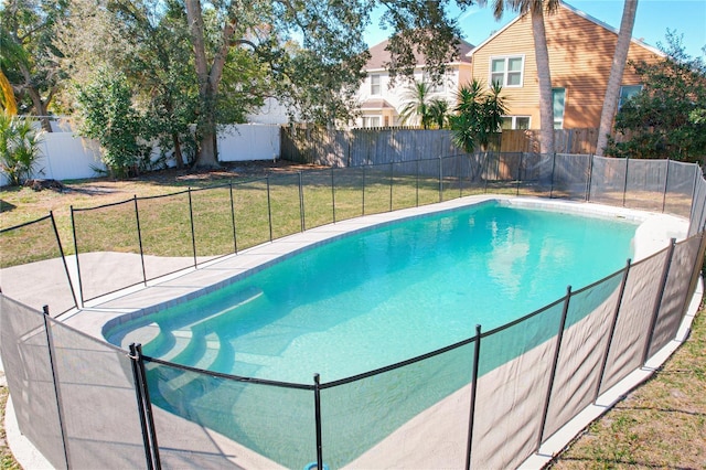 view of swimming pool featuring a lawn