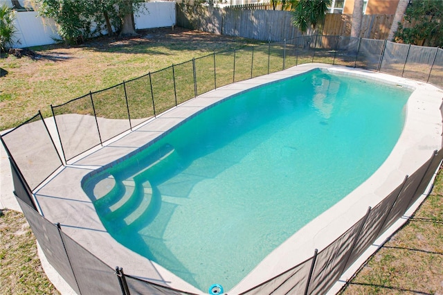 view of pool with a yard