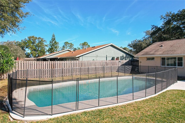 view of pool featuring a lawn