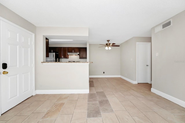 interior space with ceiling fan