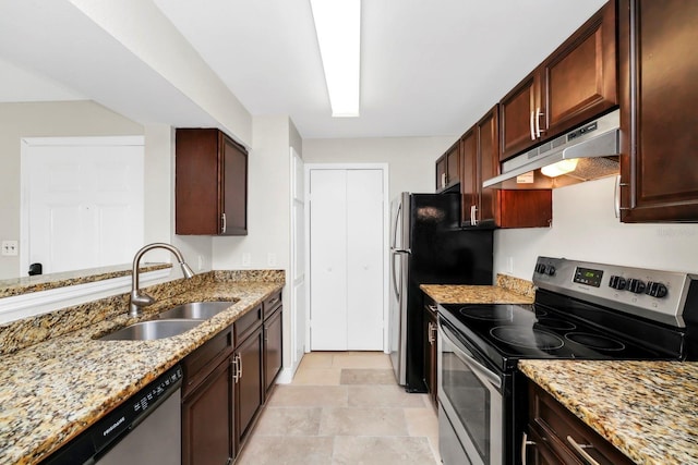 kitchen featuring sink, stainless steel appliances, and light stone countertops