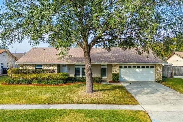 ranch-style house featuring a garage and a front lawn