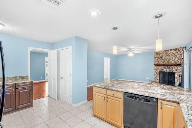 kitchen with light tile patterned flooring, light stone counters, black dishwasher, pendant lighting, and a fireplace