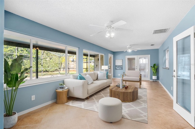 sunroom / solarium with ceiling fan and french doors