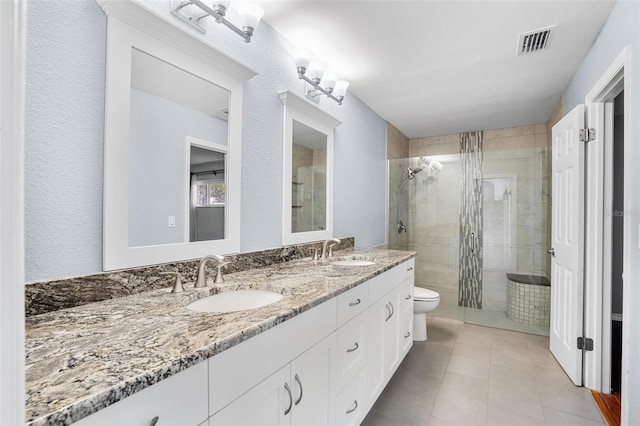 bathroom featuring vanity, tile patterned floors, toilet, and walk in shower