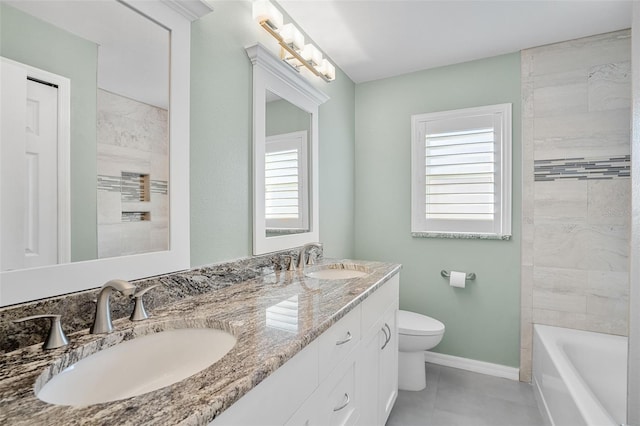 full bathroom featuring vanity, toilet, tiled shower / bath combo, and tile patterned flooring