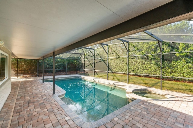 view of swimming pool featuring an in ground hot tub, a lanai, and a patio