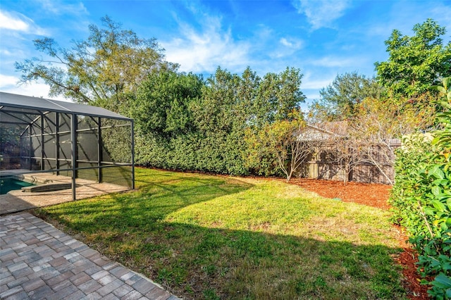 view of yard featuring a patio area and glass enclosure