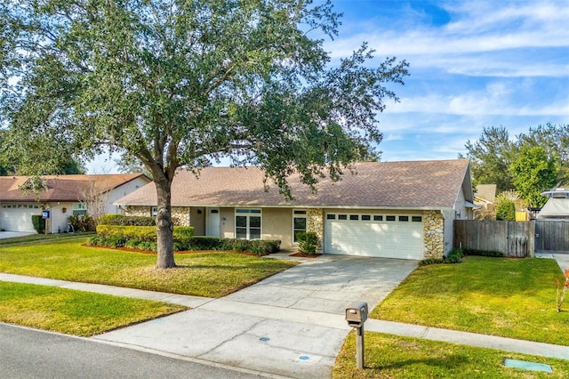 single story home featuring a garage and a front lawn