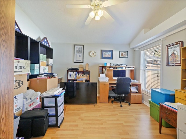 office space with ceiling fan, vaulted ceiling, and light wood-type flooring