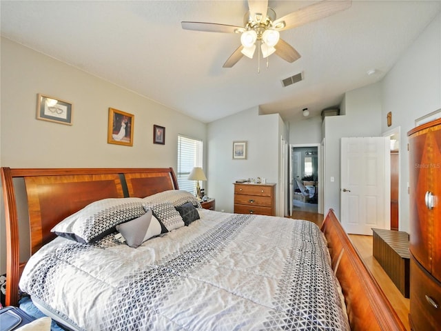 bedroom with hardwood / wood-style flooring, lofted ceiling, and ceiling fan