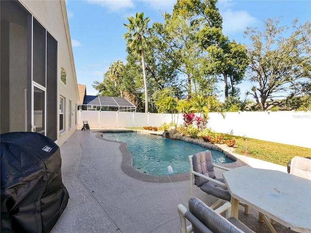 view of swimming pool featuring area for grilling and a patio area