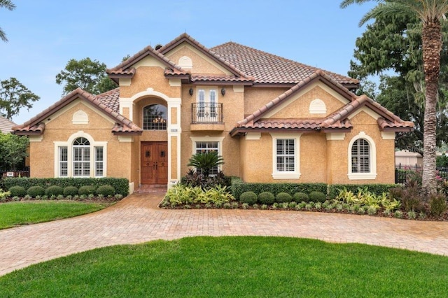 mediterranean / spanish home featuring a front yard