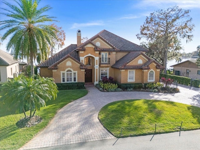 mediterranean / spanish home with a front yard