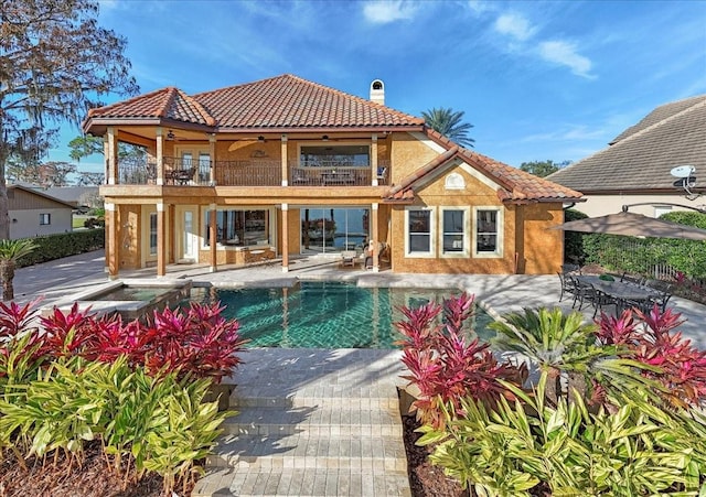 view of swimming pool featuring a patio and ceiling fan