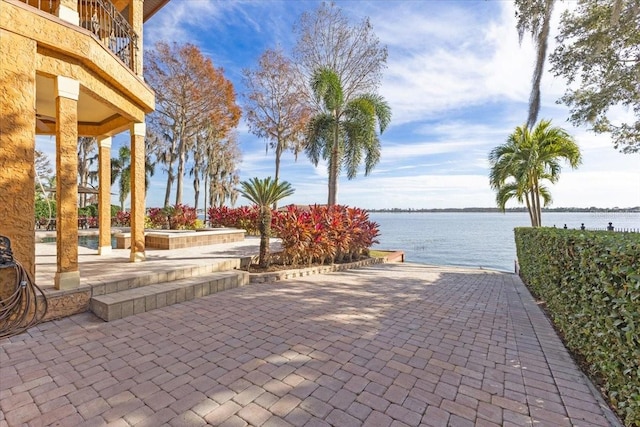 view of home's community with a patio and a water view