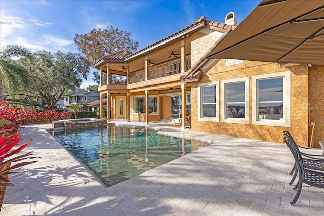 view of swimming pool featuring an in ground hot tub, ceiling fan, and a patio