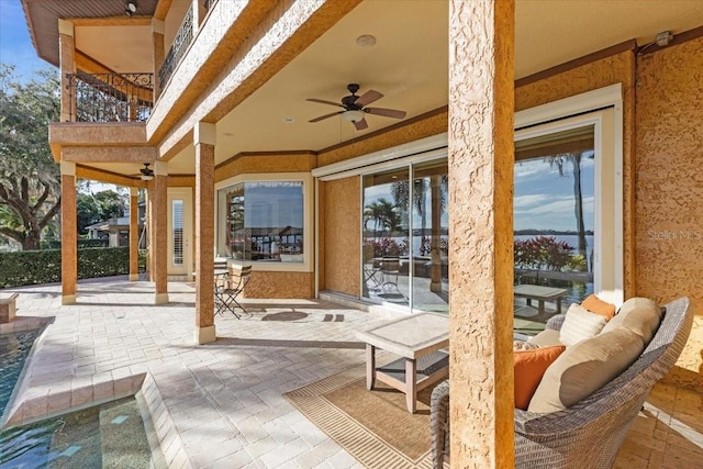 view of patio featuring a balcony and ceiling fan