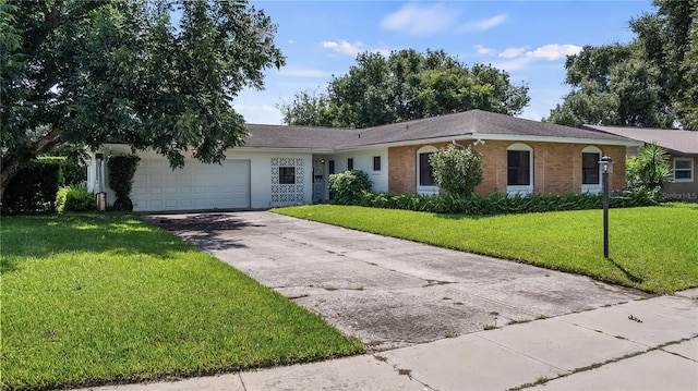 ranch-style home with an attached garage, a front lawn, concrete driveway, and brick siding