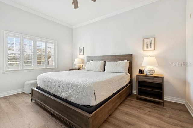 bedroom with crown molding, ceiling fan, and hardwood / wood-style floors