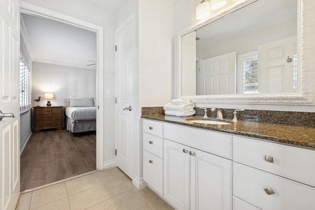 bathroom with vanity, ornamental molding, and tile patterned floors