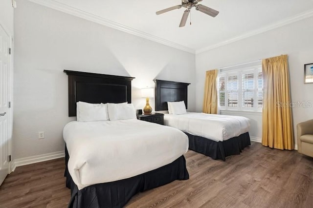 bedroom with crown molding, ceiling fan, and dark hardwood / wood-style flooring