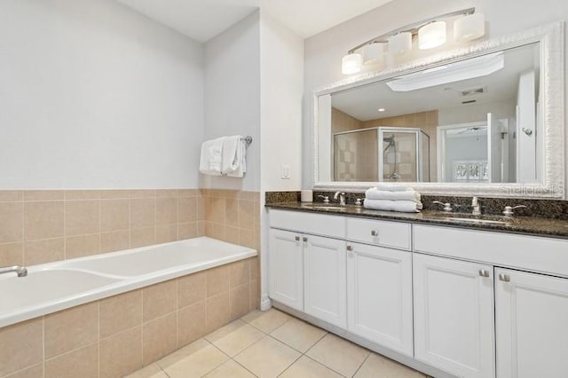 bathroom featuring vanity, shower with separate bathtub, and tile patterned floors