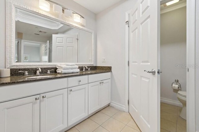 bathroom featuring tile patterned floors, toilet, and vanity