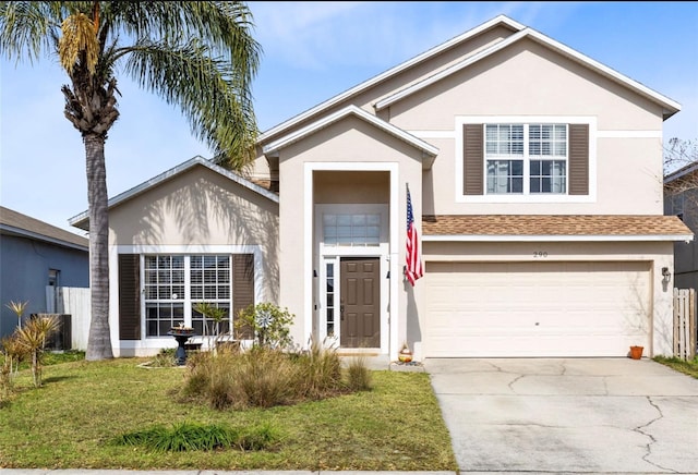 view of front of property with a garage and a front lawn