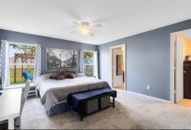 bedroom with light carpet and ceiling fan