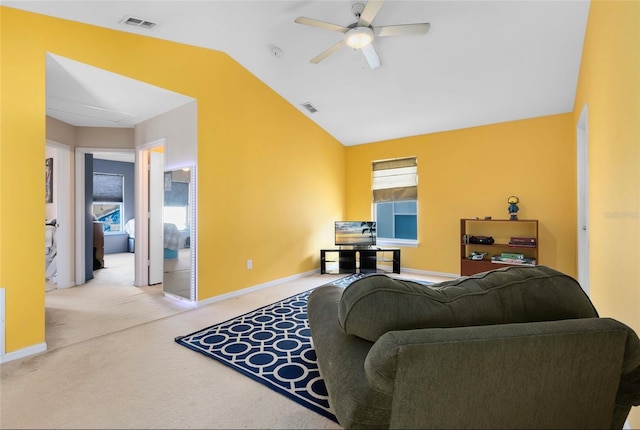 carpeted living room with vaulted ceiling and ceiling fan