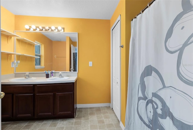 bathroom with vanity, tile patterned floors, and a textured ceiling