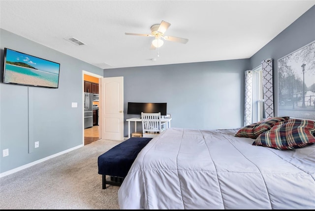 carpeted bedroom with stainless steel refrigerator and ceiling fan