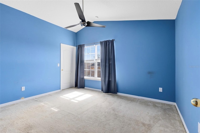 empty room featuring light carpet, lofted ceiling, and ceiling fan