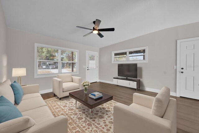 living room featuring wood-type flooring, vaulted ceiling, and ceiling fan