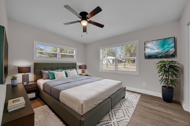 bedroom featuring ceiling fan, lofted ceiling, and hardwood / wood-style floors