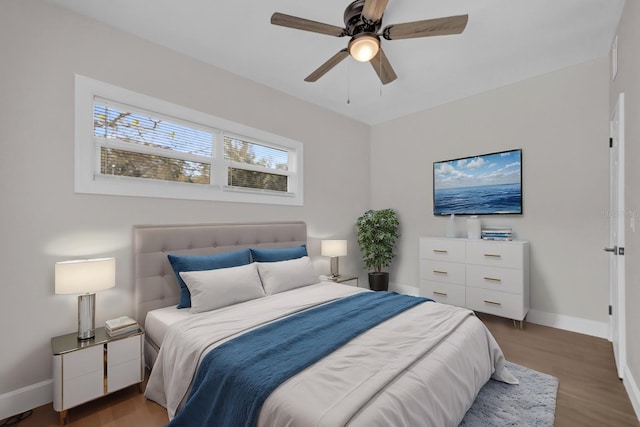 bedroom with dark hardwood / wood-style flooring and ceiling fan