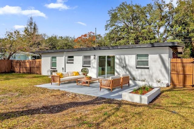 rear view of property featuring a patio area, an outdoor hangout area, and a lawn