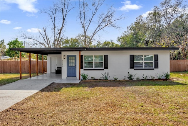 single story home with a front yard and a carport