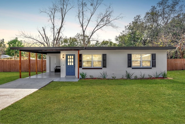 single story home with a carport and a yard