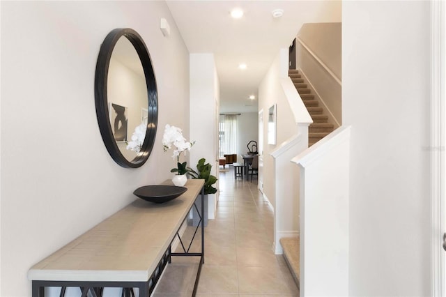 hall featuring light tile patterned floors