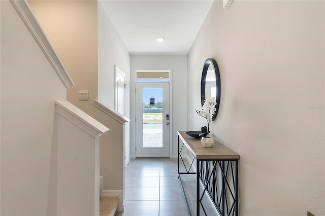 doorway to outside with tile patterned floors