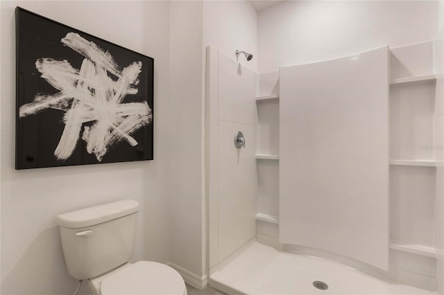 bathroom with a shower and toilet