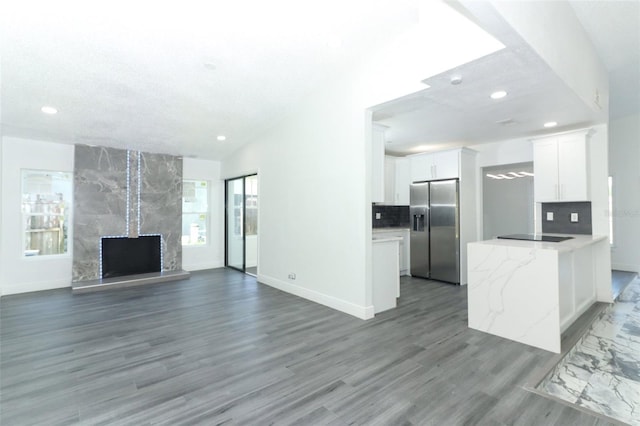 unfurnished living room featuring dark wood-type flooring and a fireplace