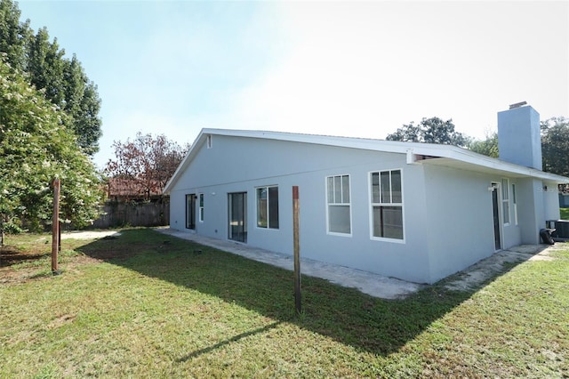 view of side of home with a lawn