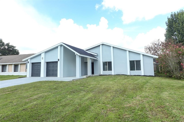 view of front of property with a garage and a front yard