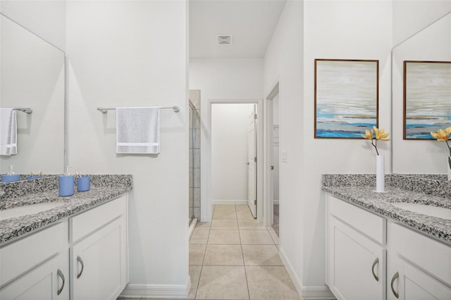 bathroom with tile patterned flooring, vanity, and a shower with shower door