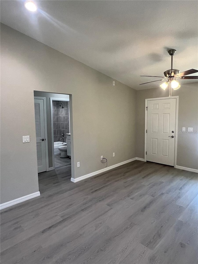 empty room with ceiling fan and hardwood / wood-style floors